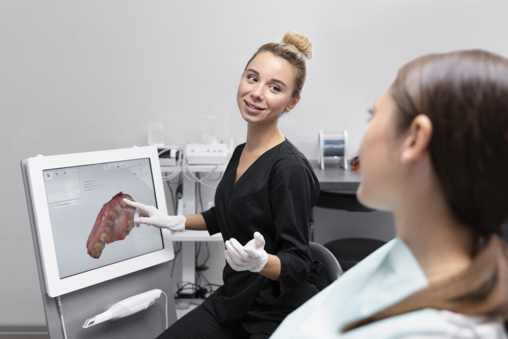 Dental implant specialist showing patient digital treatment plan for full mouth dental implants
